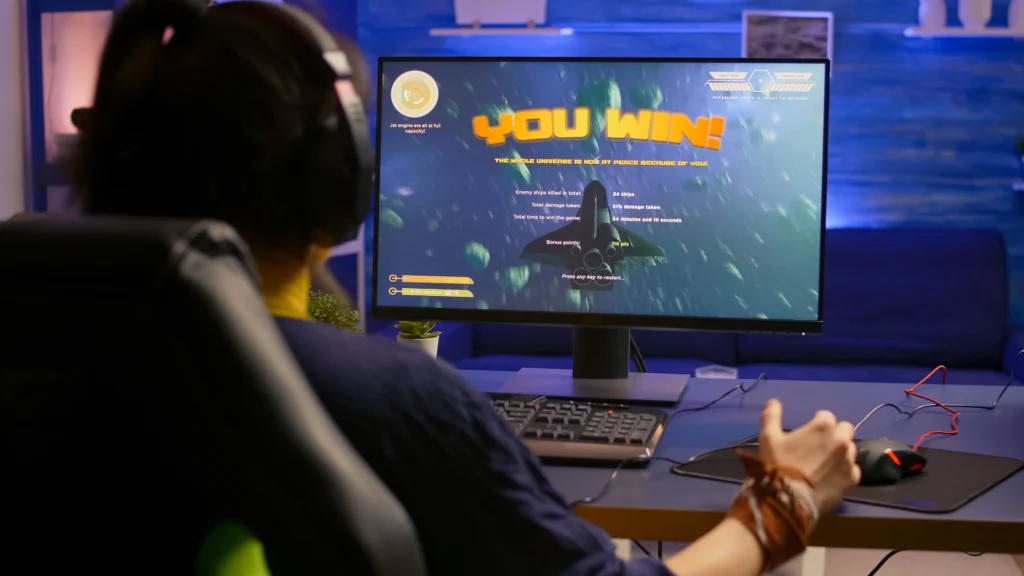 gamer-making-winner-gesture-while-playing-video-games